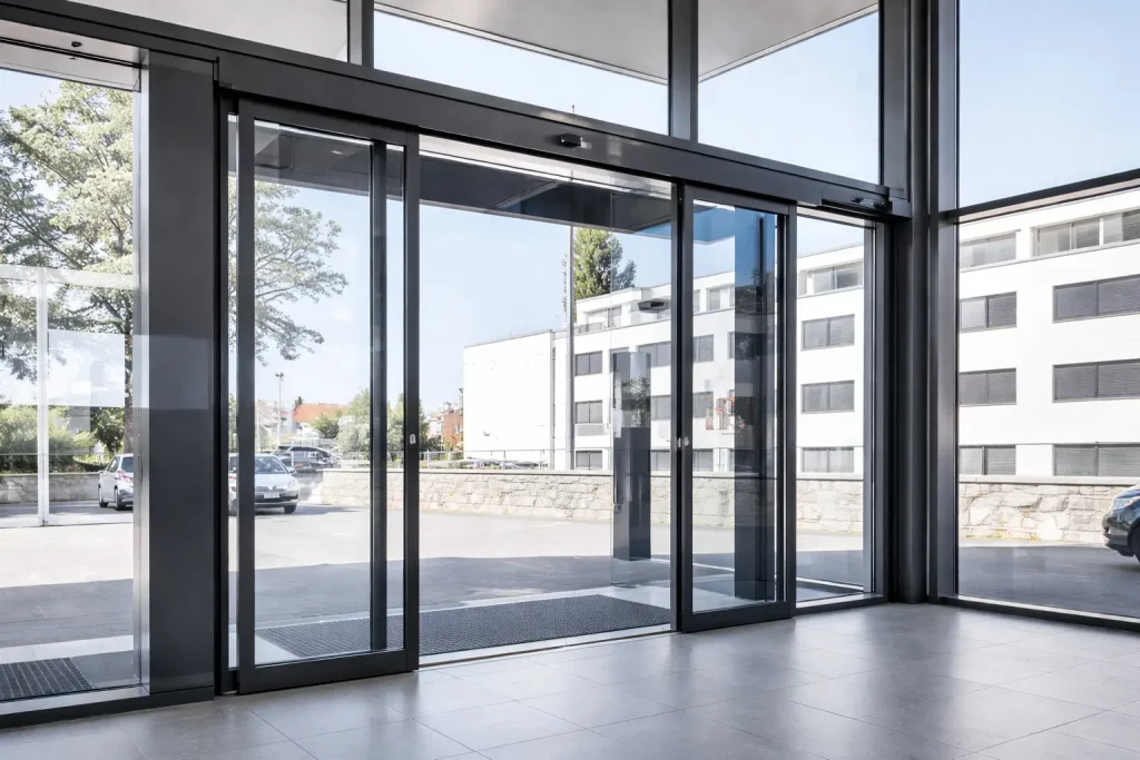 Automatic sliding glass doors leading to an outdoor view