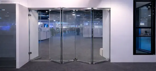 Frameless bi-folding glass doors in an exhibition setting